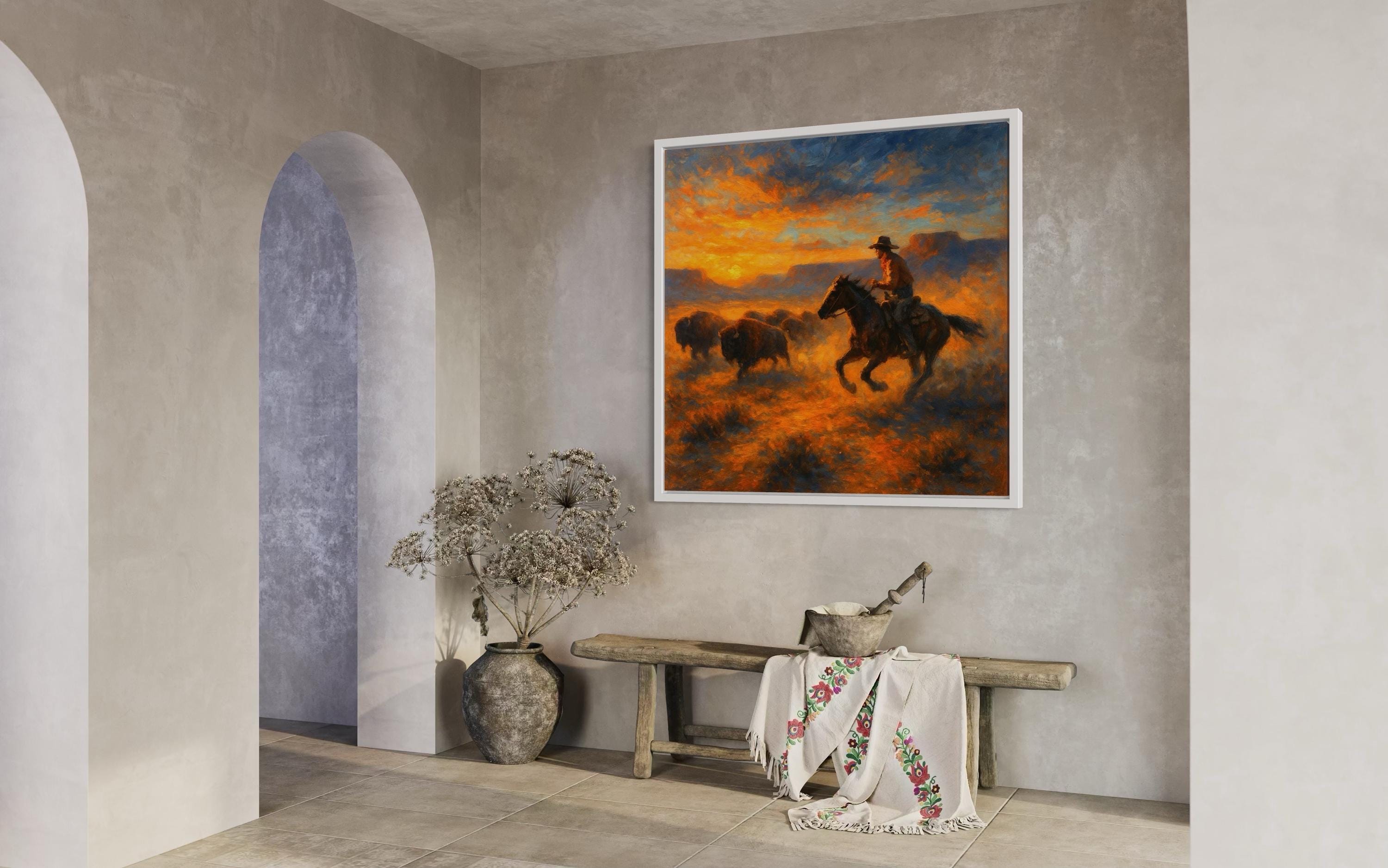 Western sunset painting showing a rider on horseback herding a buffalo herd across an orange and blue sky detail view