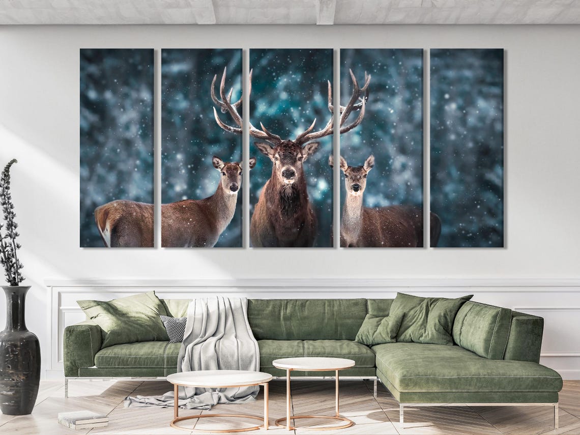 Room mockup with a landscape artwork of three deer in a snowy blue forest