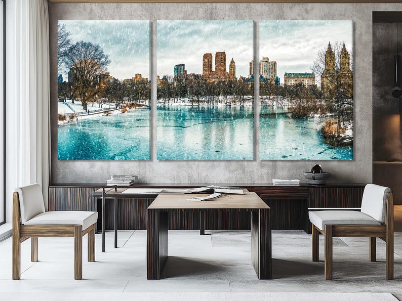 Winter city skyline over a frozen lake with falling snow and teal ice reflections