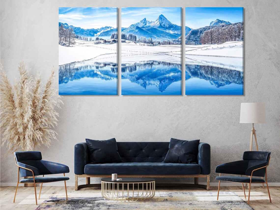 Room mockup showing a wall with a panoramic snowy mountain landscape artwork above a sofa