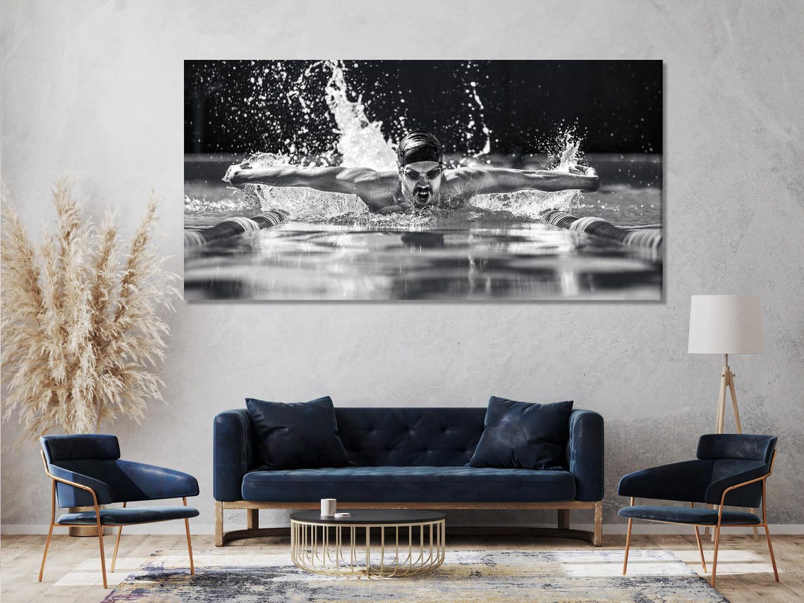Black-and-white triptych of a swimmer in mid-butterfly stroke with water splashes and droplets detail view