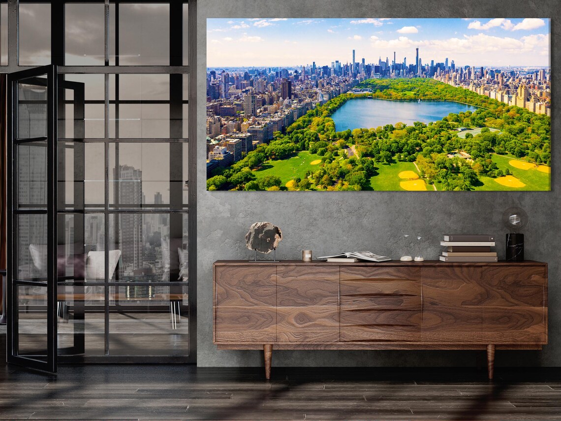 Kitchen mockup with three framed aerial cityscape panels above a dining table