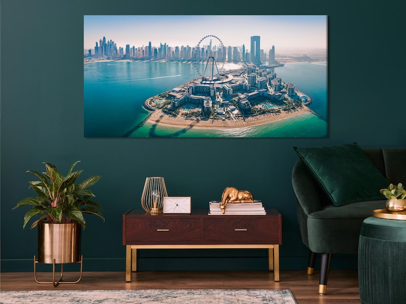 Aerial city skyline over turquoise harbour water with a large Ferris wheel on a foreground island