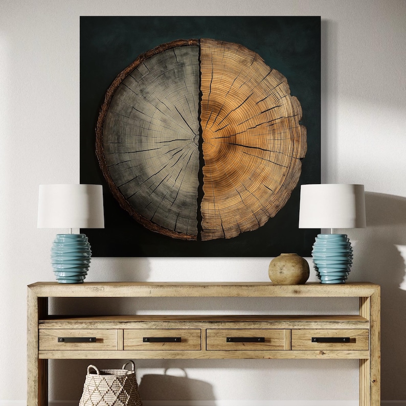 Circular tree trunk cross-section with growth rings in cool grey and warm gold tones against a dark background