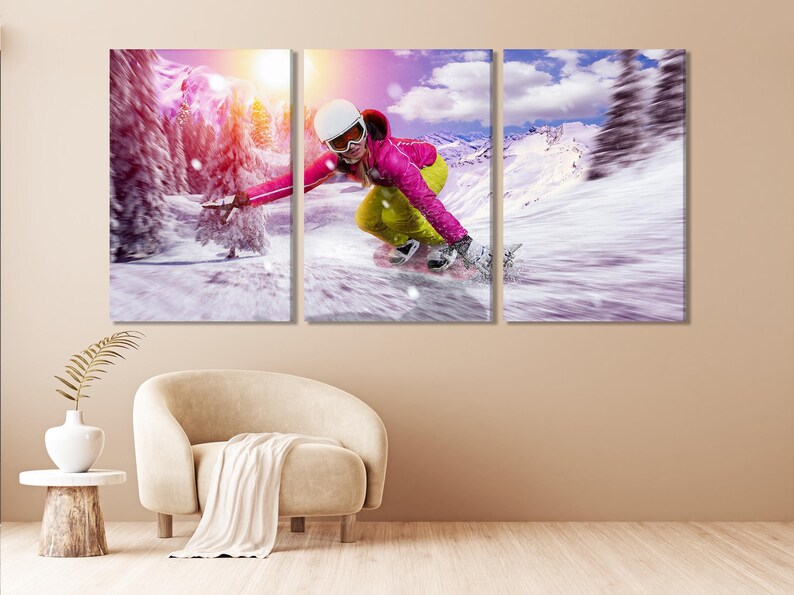 Snowboarder in bright pink and yellow carving down a snowy mountain with motion blur