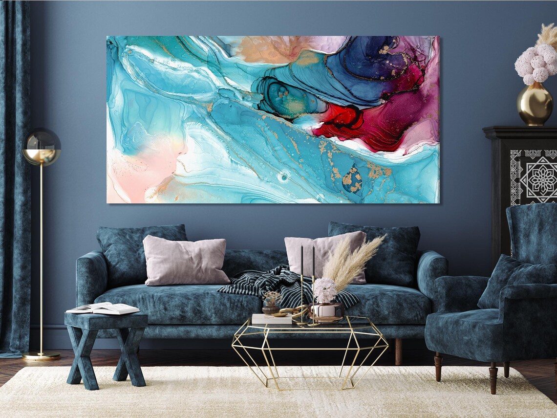 Fluid abstract five-panel artwork on a concrete wall above a sofa in a modern room