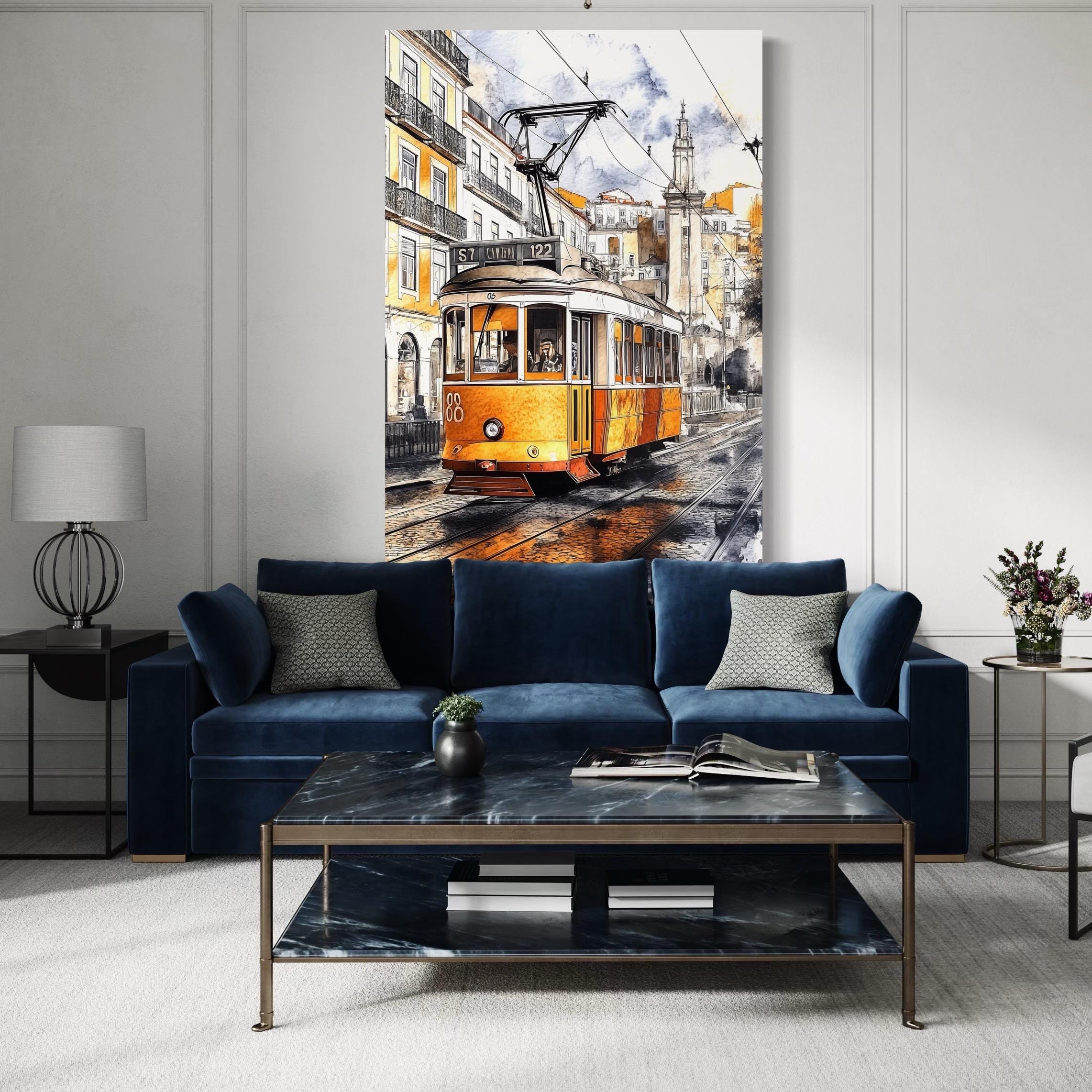 Artwork of a yellow tram cityscape hanging above chairs and a table in a bright room