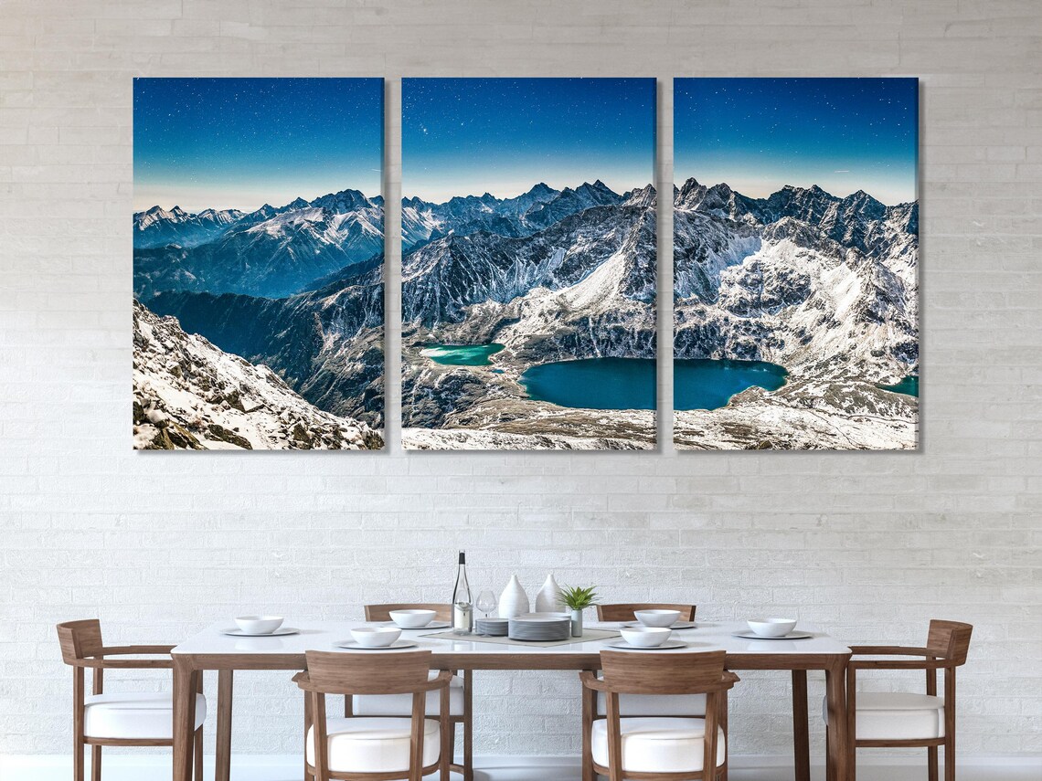 Room mockup showing vertical winter mountain artworks above a sofa