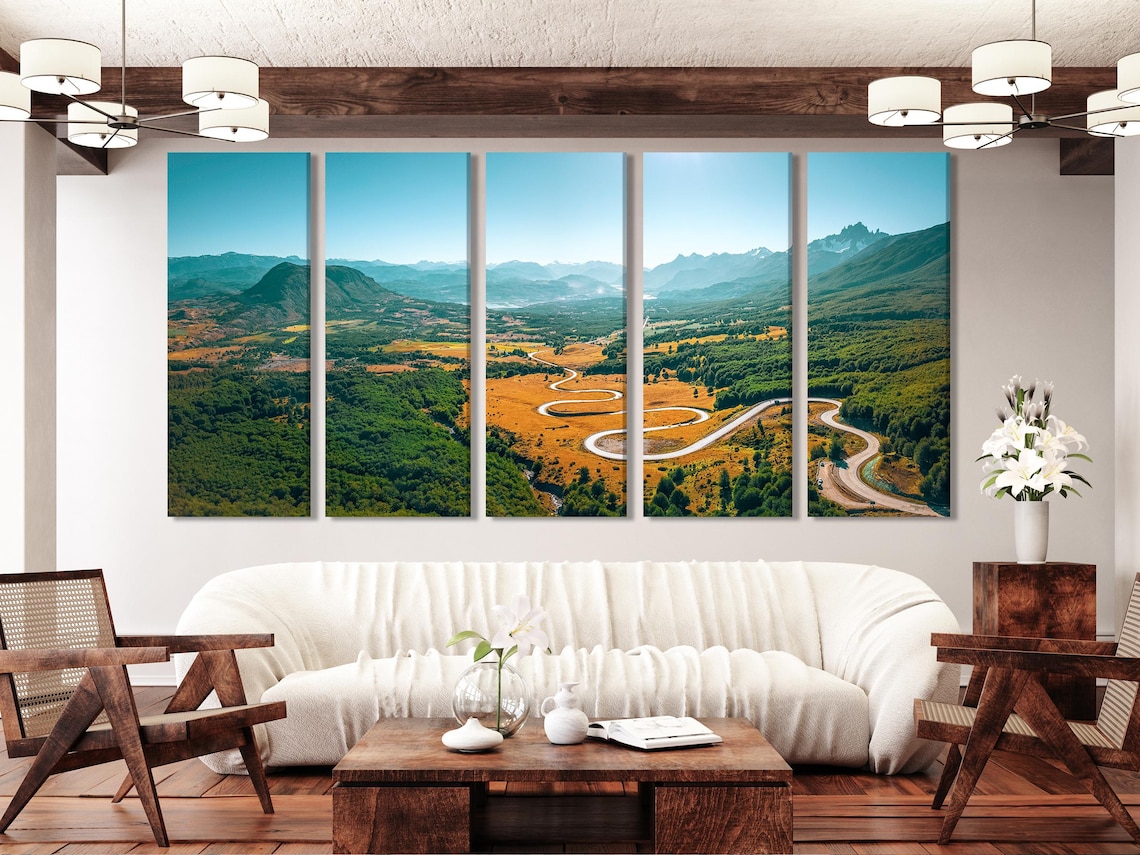 Artwork displayed in a modern living room above a white sofa with cushions and side table