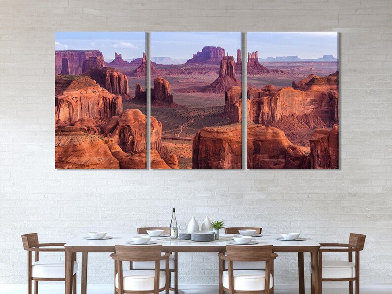 Desert canyon with red rock formations and pale blue sky