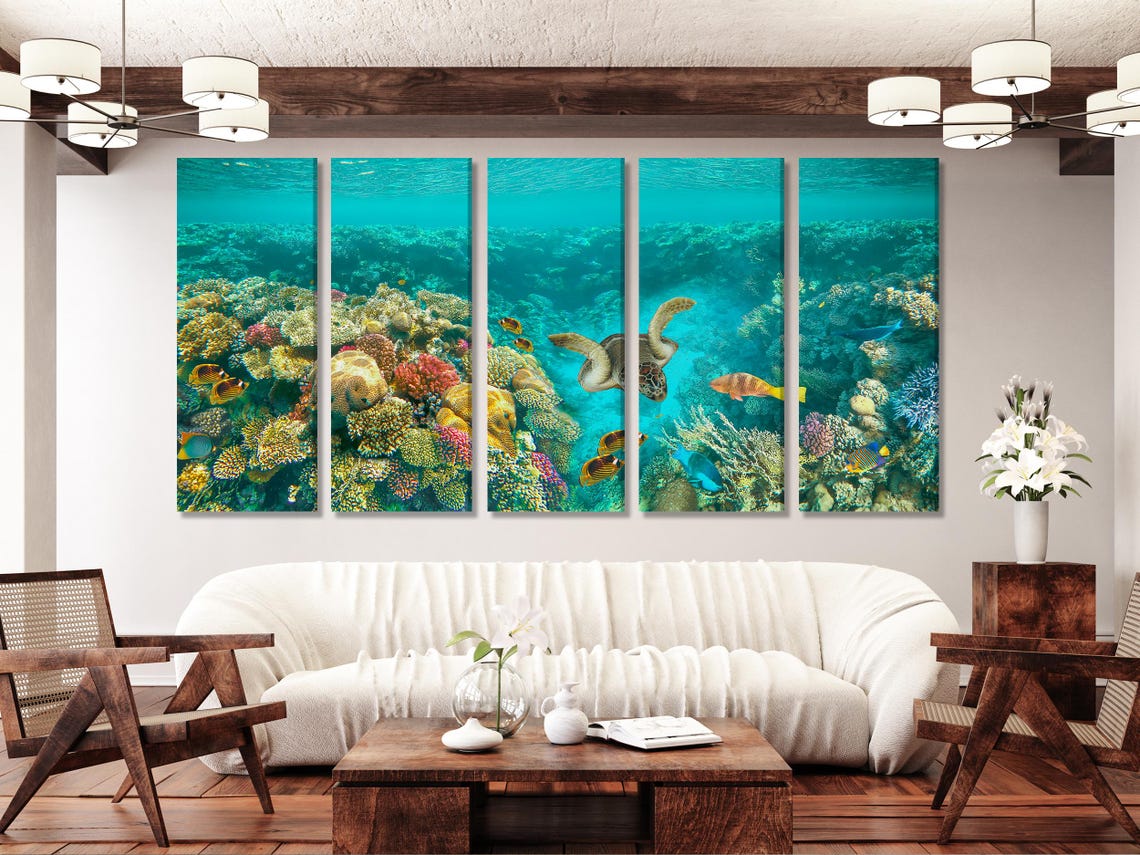 Underwater coral reef scene with a sea turtle swimming among tropical fish in turquoise water detail view