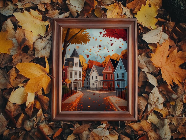 K&ouml;nnte beinhalten: Ein gerahmtes Kunstwerk mit Herbstthema, das eine Stra&szlig;e mit bunten H&auml;usern zeigt. Die H&auml;user sind in Wei&szlig;, Rot und Blau gehalten, mit B&auml;umen in leuchtenden Herbstfarben. Das Kunstwerk ist vor einem Hintergrund aus fallenden Bl&auml;ttern mit einem braunen Rahmen.
