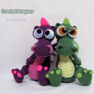 May include: Two crocheted dragon toys, one purple with pink accents and one green with yellow accents. Both dragons have large, googly eyes and are sitting on a white surface. The text "Crochet Dragons by Liliksha Toys" is visible above the dragons.