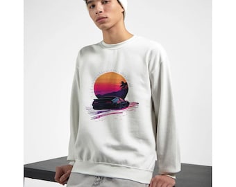 May include: White sweatshirt with a graphic print of a car driving into a sunset with palm trees. The graphic is in shades of pink, orange, yellow, and blue.