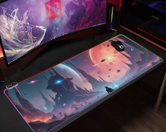 May include: A large, colourful gaming mouse mat with a futuristic space scene. The mouse mat has a black border with a multi-coloured light effect around the edge. The scene features a large, rocky structure with a blue glow, a red planet, and a small figure in the distance.