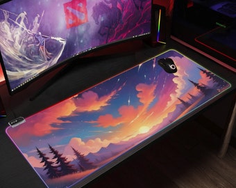 May include: A large, rectangular mouse mat with a colourful sunset scene. The mouse mat has a black border with a rainbow-coloured glow around the edges. The scene features a pink, orange, and yellow sunset with clouds and stars. There are also trees in the foreground.