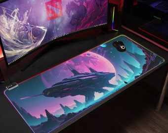 May include: A large, colourful gaming mouse mat with a futuristic spaceship design. The mat features a purple and pink nebula with a large, dark spaceship in the foreground. The mouse mat has a glowing, multi-coloured border.