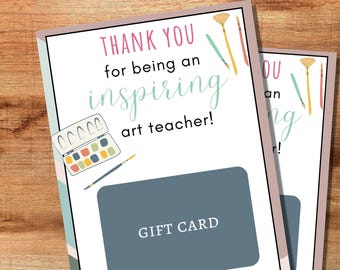 May include: A pink and white gift card with the text "Thank you for being an inspiring art teacher!" and a watercolor palette and paintbrushes. The card has a blue gift card section with the text "Gift Card".