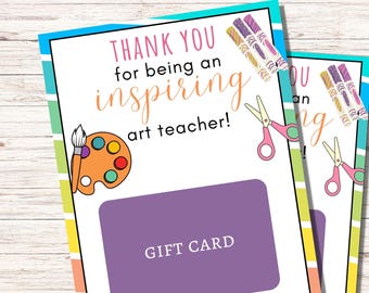 May include: A colorful gift card with a rainbow striped background. The card says "Thank you for being an inspiring art teacher!" and has a gift card space. The card also has a paint palette and paintbrush, scissors, and colored markers.