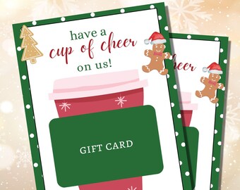 May include: Green and white gift card with a red and white coffee cup illustration. The card says "have a cup of cheer on us!" and features a gingerbread man illustration.