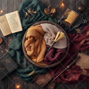 May include: A flat lay image of a brown wooden surface with a variety of items, including a book, a candle, a wand, and a variety of fabrics in shades of green, red, and gold. The fabrics are arranged in a circular pattern, with the book and candle in the centre.