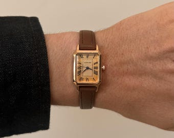 2000s vintage style rectangular gold luxury watch with leather band