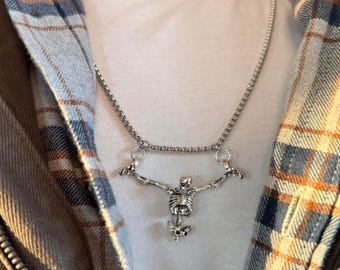 Unisex silver skeleton necklace featuring a bold, grunge-inspired design