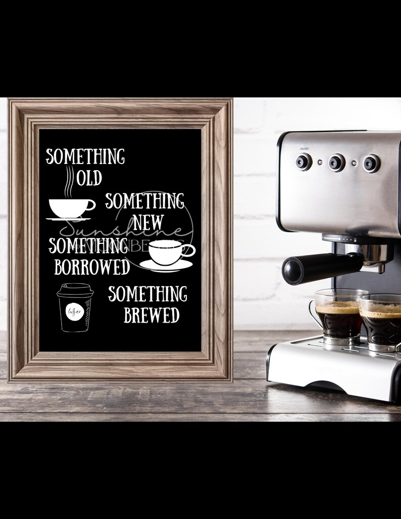 May include: A framed chalkboard sign with the text "Something Old, Something New, Something Borrowed, Something Brewed" with coffee cup illustrations. The sign is sitting on a wooden surface next to a silver espresso machine with two cups of coffee.