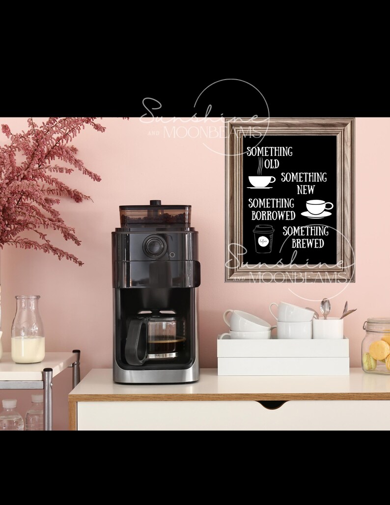 May include: A black coffee maker with a glass carafe sits on a white countertop next to a framed chalkboard sign that reads "Something Old, Something New, Something Borrowed, Something Brewed".