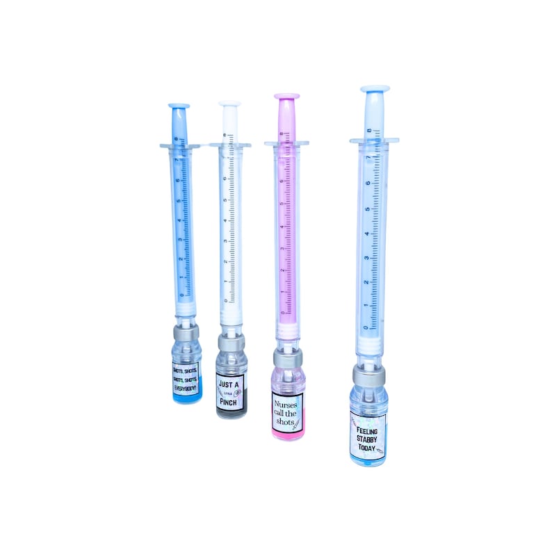 four different pens. blue pen and liquid that says shots shots shots shots everybody, white pen with gray liquid that says just a little pinch, pink pen and liquid that says nurses call the shots, blue pen and liquid that says feeling stabby today