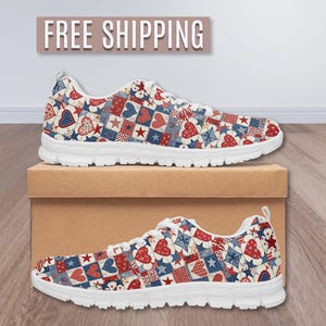 May include: Pair of white-soled sneakers with a repeating pattern of red hearts, blue stars, and geometric shapes on a cream background. The shoes are displayed on a brown box. The text "FREE SHIPPING" is above the shoes.