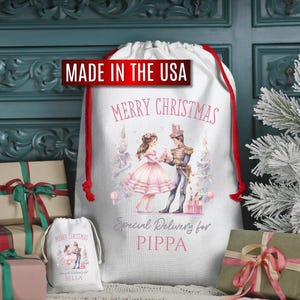May include: A white Christmas gift sack with a red drawstring, featuring a watercolor illustration of a couple and the text "Merry Christmas." The sack is labeled "Special Delivery for Pippa" and "Made in the USA."