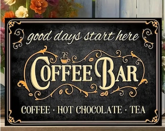 May include: A rectangular black sign with gold lettering and accents, advertising a coffee bar. The sign reads "good days start here" at the top, with "COFFEE BAR" in large letters. Below, it lists "COFFEE • HOT CHOCOLATE • TEA". The sign is 12 inches wide and 8 inches tall.