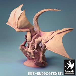 May include: A pre-supported 3D printed model of a dragon with wings outstretched, perched on a rocky base. The model is printed in a light pink color.