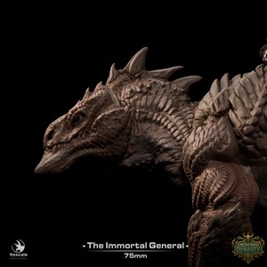 May include: A brown, unpainted resin miniature of a reptilian creature with textured scales, sharp dorsal spines, and a defined snout. The base text reads: - The Immortal General - 75mm. The figure features intricate detailing across the neck and shoulder area.