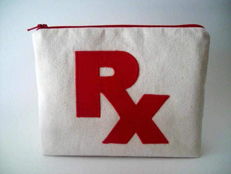 May include: A white canvas zippered pouch with a red felt "Rx" design.