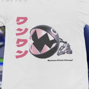 May include: White t-shirt featuring a Chain Chomp graphic with Japanese text and the words "Wanwan (Chain Chomp)". The Chain Chomp is black with pink teeth and a chain.