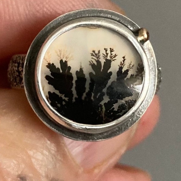 Scenic Black Dendritic Agate ring. Dendritic Agate set on a unique torch layered Sterling ring band with 14 Kt Gold embelishement. Size 6.