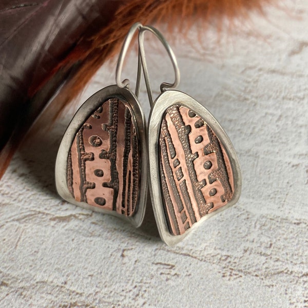 Tribal print, Sterling and Copper earrings. Slightly curved triangular shaped Copper and Sterling Silver drop earrings. Mixed Metal jewelry.