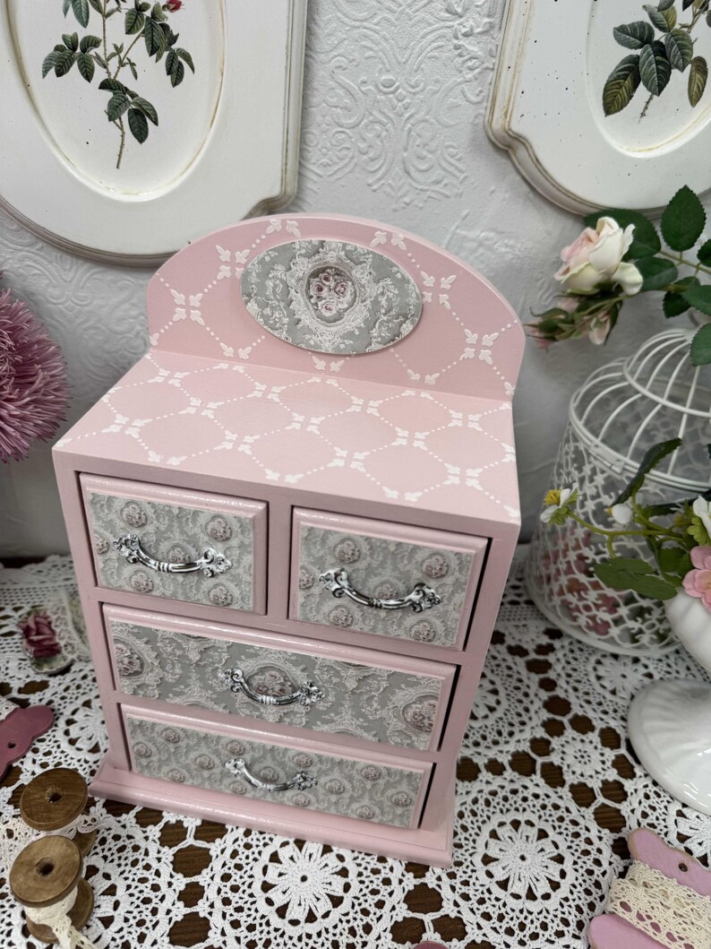Handcrafted wooden dresser-style jewelry and craft organizer with pink and gray tones, decorated with hand-painted roses, featuring a textured surface and acrylic lacquer finish — perfect as a gift for mom, sister, or daughter.