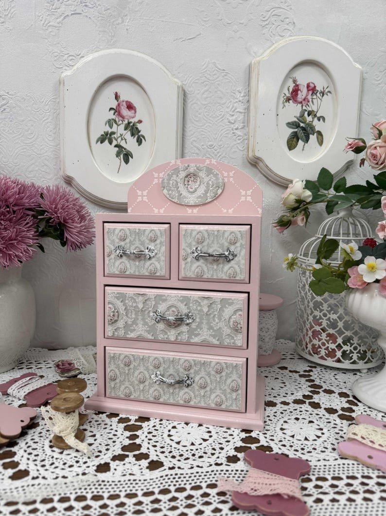Handcrafted wooden dresser-style jewelry and craft organizer with pink and gray tones, decorated with hand-painted roses, featuring a textured surface and acrylic lacquer finish — perfect as a gift for mom, sister, or daughter.