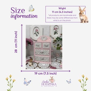 May include: A pink wooden jewelry box with five drawers and a decorative top. The box is 11 inches wide, 7.5 inches deep, and 11 inches tall. The drawers have a floral pattern. The text "Size information" is visible.