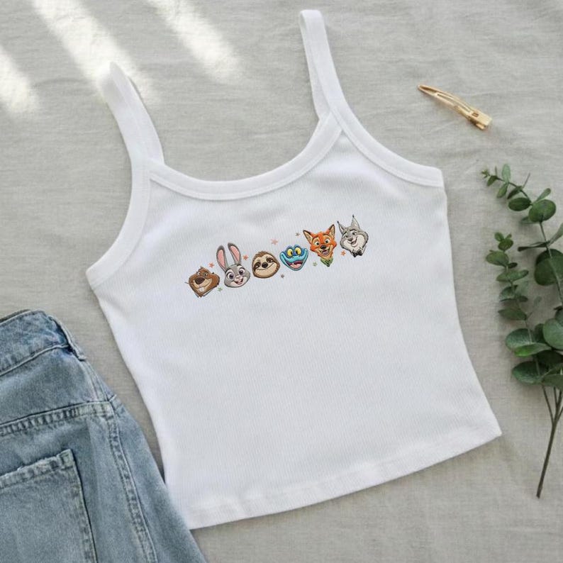 May include: A white ceramic mug with a black handle and the text "But First, Coffee" in a black, handwritten-style font. The mug is on a white surface.