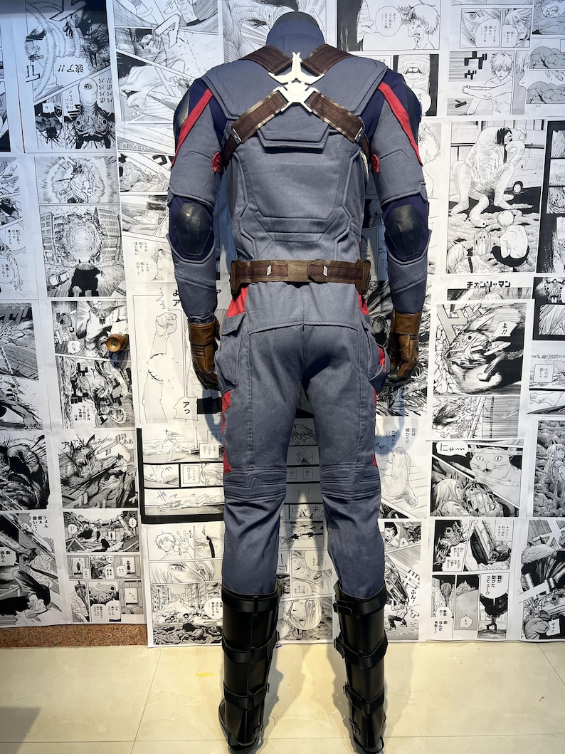 May include: A blue and red superhero costume with a brown leather belt and black boots. The costume has a detailed design with a star on the chest and a red and blue pattern on the arms and legs.