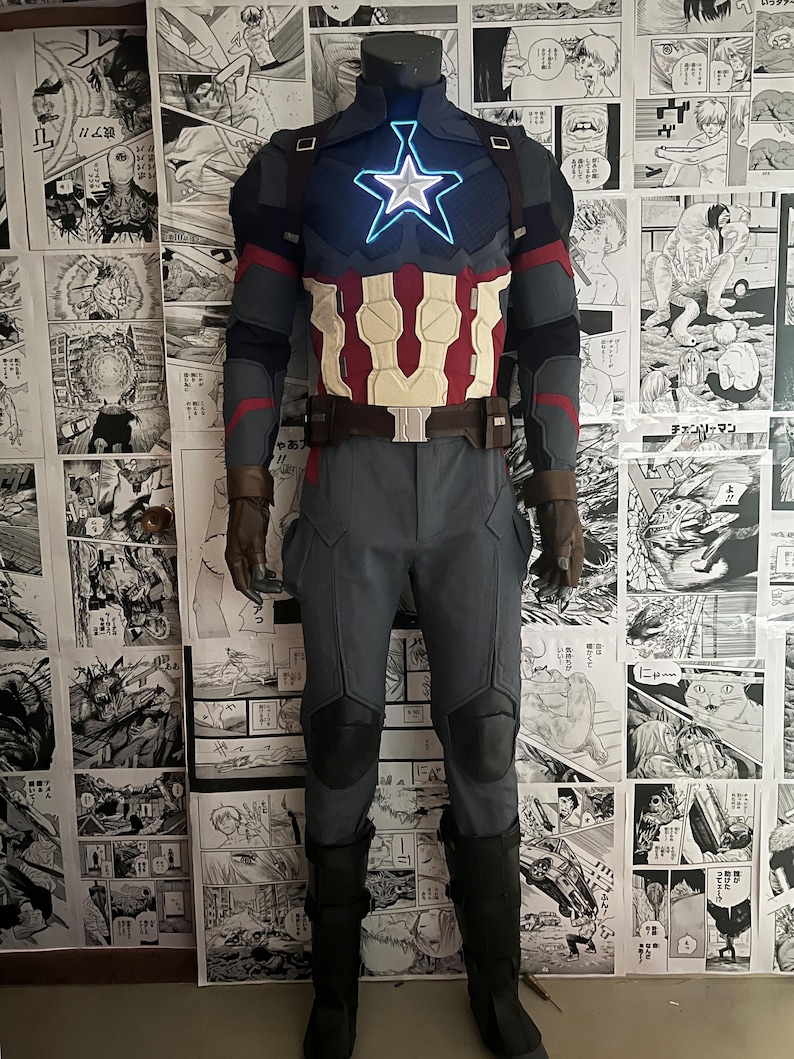 May include: A blue and red superhero costume with a large star on the chest. The star is lit up with blue lights. The costume includes a belt, pants, and boots.