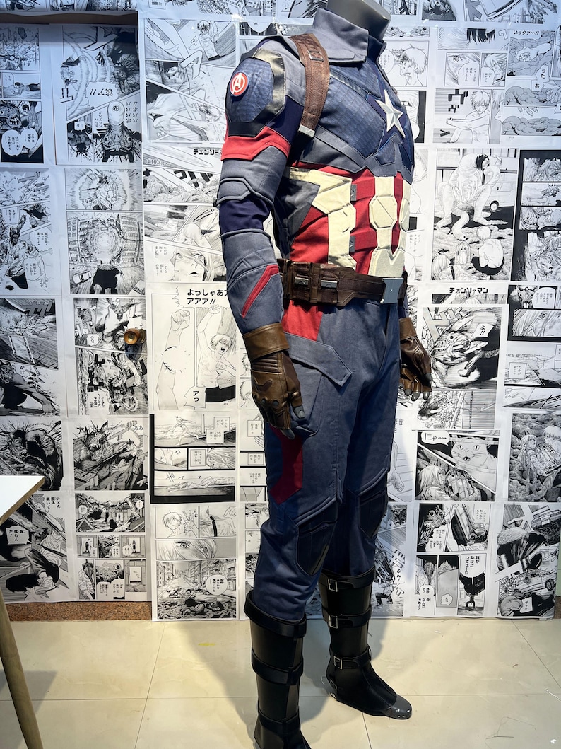 May include: A blue and red superhero costume with a star on the chest. The costume includes a jacket, pants, and boots. The boots are black with a brown leather strap.