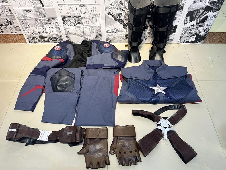 May include: A Captain America costume set with a blue and red jacket, pants, and a chest piece with a star. The set also includes a pair of brown leather gloves, a black belt with a silver buckle, and a pair of black boots.