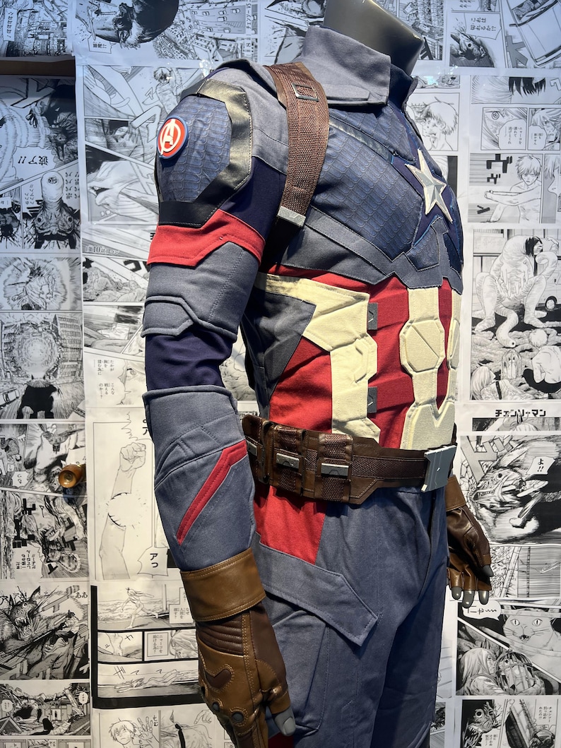 May include: A blue and red superhero costume with a brown leather belt and gloves. The costume has a star on the chest and a red, white, and blue shield on the arm.