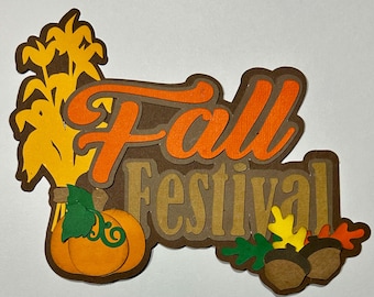 May include: Fall Festival paper craft with a brown background, orange "Fall" lettering, a brown "Festival" lettering, a yellow corn stalk, and a brown pumpkin with green leaves.