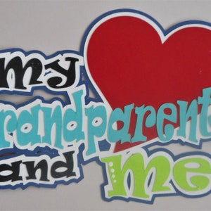 May include: A layered paper craft with the words "my grandparents and me" in a playful font. The design includes a red heart and text in black, blue, and green, with white outlines and a blue border.